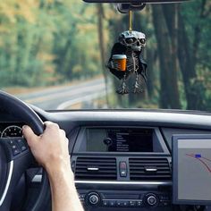 a car dashboard with a skeleton hanging from the dash board