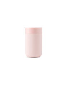 a pink cup sitting on top of a white table