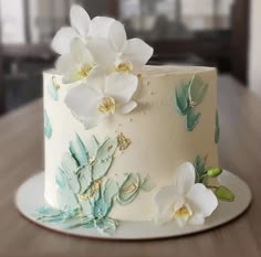 a white and blue cake with flowers on it