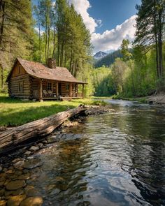 a log cabin sitting on the side of a river