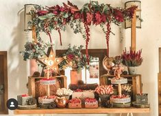 an assortment of holiday treats on a table in front of a christmas wreath and garland