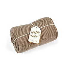 the product is wrapped in brown linen and has a white tag that says with love on it