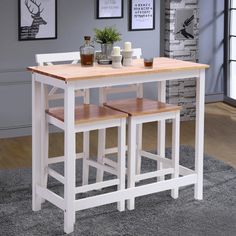 a kitchen table with two stools in front of it