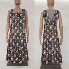 two mannequins with skulls and flowers on them, one is wearing a dress