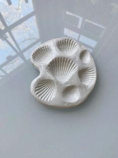 a white ceramic dish sitting on top of a table