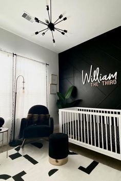 a baby's room with black and white decor