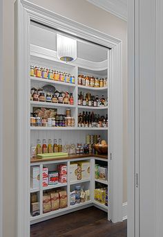 an open pantry with lots of food and condiments on the shelves in it