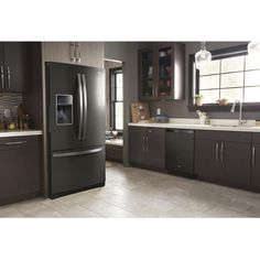 a modern kitchen with stainless steel appliances and dark wood cabinets, along with tile flooring