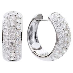 These beautiful hoop earrings are made of 4.9 grams for 18 karat gold. Each one has 3 rows of stunning VS2, G color diamonds. The total diamond weight is 1.37 carats, which is made up of 50 round diamonds. These earrings are securely closed with a post that locks into the back with a click. White Gold Drop Earrings, Modern Hoop Earrings, Italian Blue, Gold Diamond Hoop Earrings, White Gold Hoops, Blue Sapphire Diamond, Diamond Hoop Earrings, Gold Drop Earrings, Jewelry Earrings Hoops