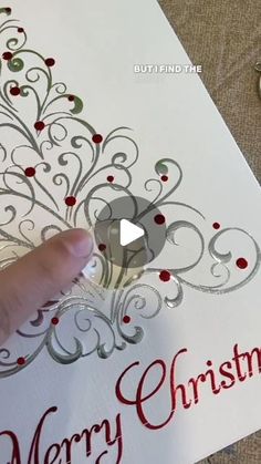 someone is cutting out a christmas card with scissors