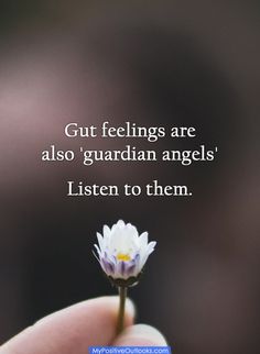 a hand holding a flower with the words, gut feelings are also guardian angels listen to them