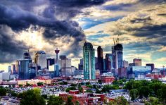 the city skyline is shown under a cloudy sky