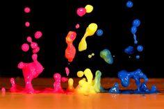 colorful paint splashing on the floor with black background