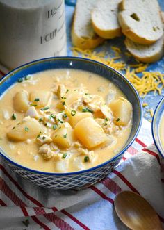 two bowls of soup with bread on the side and one bowl filled with chicken noodle soup