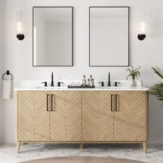 a bathroom with two mirrors and double sinks