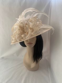 This is an ivory Elegant wide turn-down Brim sinamay hat perfectly styled  with cream long feathers and beige sinamay bows for Kentucky derby, Belmont, Steeplechase, Melbourne cup, or any other hat wearing races event. Great for COGIC Women's  convention church hat and is  lovely for spring/summer wedding for Mother of the bride or guest hat.  Looking for a great tea Party headpiece or Mother of the bride Brunch hat, This is perfect for any special occasion.  Lightweight  Can be worn on either side Only one made! Elegant Summer Fascinator With Feather Trim, Wedding Wide Brim Feather Trim Fascinator, Wedding Wide Brim Fascinator With Feather Trim, Elegant Feather Trim Top Hat For Party, Elegant Party Top Hat With Feather Trim, Summer Wedding Fascinator With Feathers, Elegant Wedding Headpiece With Feather Trim, Wide Brim Feather Trim Fascinator For Kentucky Derby, Kentucky Derby Wide Brim Fascinator With Feather Trim