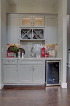 a kitchen with gray cabinets and white appliances in the middle of the room is shown