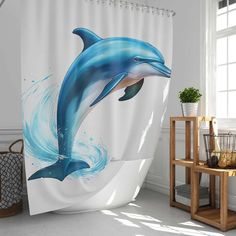 a shower curtain with a blue dolphin on it's side and water splashing from the bottom