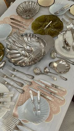 an assortment of silverware on a table