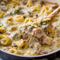 a skillet filled with pasta and meat covered in sauce