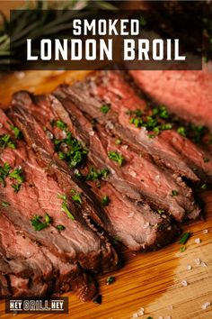 sliced steak on a cutting board with parsley garnish and text that reads smoked london broil