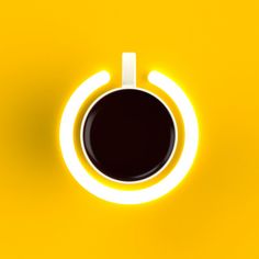 a cup of coffee sitting on top of a yellow table