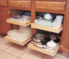 there are two shelves in the kitchen with pots and pans