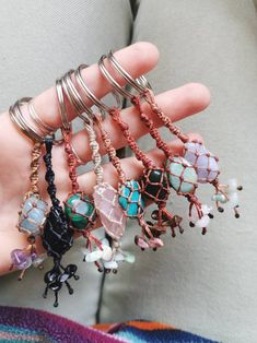 a person is holding several bracelets in their hand