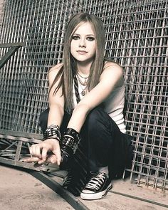 a woman sitting on the ground with her hands crossed