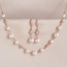 "* White with Rose Gold Pearl Earring & Necklace Set * * White with a touch of rose gold crystal round pearls linked together in a light and airy necklace complimented with a rose gold-filled chain and a rose gold tone clasp in 16\", 17\", or 18\" lengths. This necklace is perfect for a beach wedding! * More pictures to come! * TAKE 10% OFF $75 OR MORE WITH COUPON CODE ~ WEDDINGS10 * TAKE 15% OFF $100 OR MORE WITH COUPON CODE ~ WEDDINGS15 * This set will arrive in a box tied with a ribbon perfec Elegant Rose Gold Pearl Necklace For Wedding, Rose Gold Pearl Necklace With Charm For Wedding, Rose Gold Pearl Drop Necklace For Wedding, Delicate Rose Gold Pearl Necklace For Wedding, Rose Gold Pearl Charm Jewelry For Wedding, Mother Of The Bride Rose Gold Pearl Jewelry, Rose Gold Pearl Necklace, Pretty Gold Necklaces, Stylish Jewelry Accessories