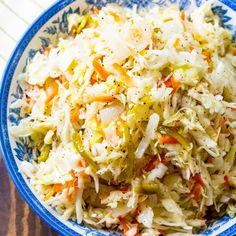 a blue and white bowl filled with coleslaw