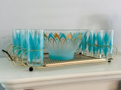 a set of blue glasses sitting on top of a shelf