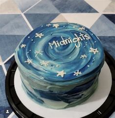 a cake that is sitting on top of a black and white plate with the words midnights written in frosting