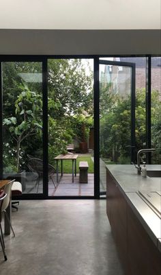 an open kitchen and dining area with sliding glass doors leading to the back yard outside