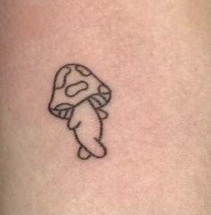 a small tattoo of a mushroom on the back of a woman's leg,