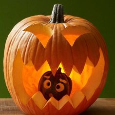 a carved pumpkin with an evil face on it