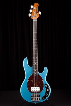 a blue and brown guitar sitting on top of a table