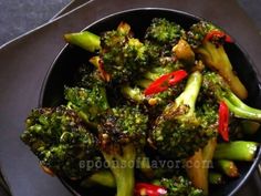 broccoli with red peppers in a black bowl