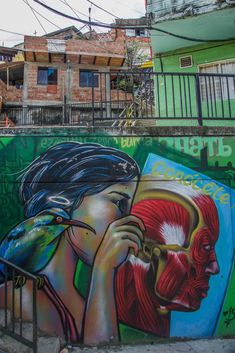 a mural on the side of a building that reads, writing comuna 13 medilin