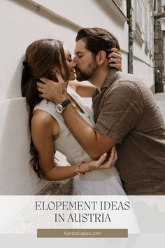 a man and woman kissing in front of a white wall with the words, elopement