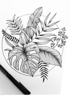 a black and white drawing of leaves on paper with a pen in the foreground