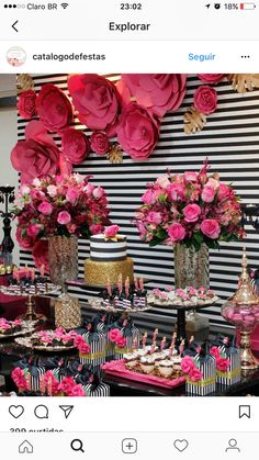 a table topped with cakes and cupcakes covered in pink flowers