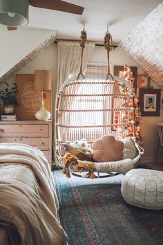 a bedroom with a hanging chair in the corner