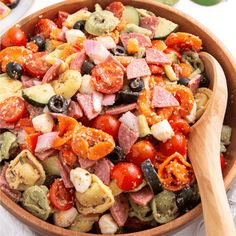 a wooden bowl filled with lots of different types of food