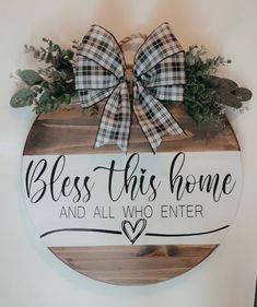 a wooden sign that says, bless this home and all who enter