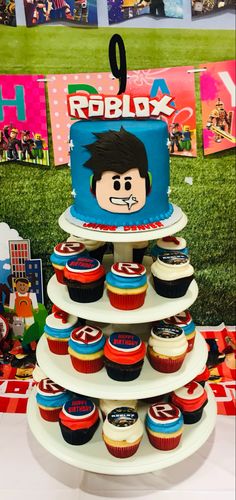 a cake and cupcakes on a table at a children's birthday party