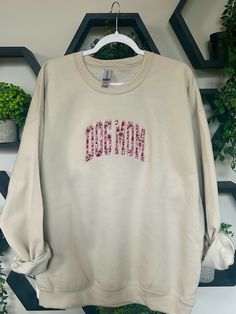 This Dog Mom Crewneck is the perfect sweatshirt to wear on your next trip to the park or to snuggle with your pups! This design features a pink floral fabric that is embroidered on a Gildan Heavy Blend Sand Crewneck. This crewneck runs slightly oversized. I recommend sizing up for an oversized fit. Pink Sweatshirt With Embroidered Logo For Spring, Pink Embroidered Sweatshirt With Relaxed Fit, Pink Embroidered Relaxed Fit Sweatshirt, Pink Relaxed Fit Sweatshirt With Letter Embroidery, Relaxed Fit Pink Sweatshirt With Embroidered Graphics, Spring Pink Sweatshirt With Embroidered Graphics, Pink Embroidered Sweatshirt For Spring, Pink Sweatshirt With Custom Embroidery In Relaxed Fit, Pink Cotton Sweatshirt With Floral Embroidery