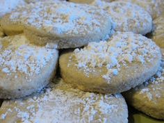 powdered sugar covered cookies are piled on top of each other