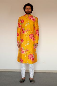 Yellow longline achkan in chanderi silk base fabric with floral motif prints. Paired with silk kurta and white cotton satin pant.
Component: 3
Pattern: Printed
Type Of Work: Floral Motifs
Neckline: Band
Sleeve Type: Straight
Fabric: Chanderi Silk; Cotton Satin; Lining: Cotton
Color: Yellow
Other Details: 
Front button placket kurta
Cuff sleeves kurta
Front button down achkan
Side slit kurta
Occasion: Wedding - Aza Fashions Men Haldi Outfit, Haldi Outfit For Bride, Achkan For Men, Haldi Dress, Boys Kurta Design, Mehendi Outfit, Haldi Outfits, Sunset Yellow, Haldi Outfit