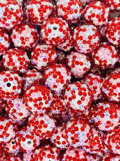 many red and white beads are stacked on top of each other in the shape of skulls